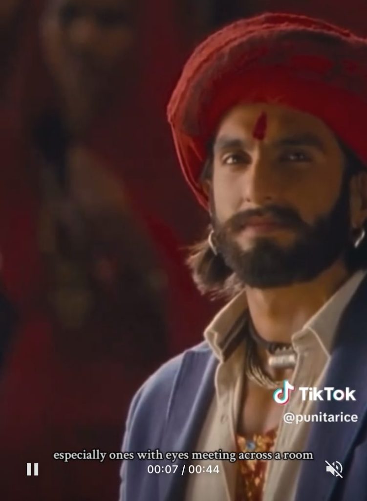 Ranveer Singh's Ram and Deepika Padukone's Leela looking at one another in "Nagada Sang Dhol" (from Ram-Leela).